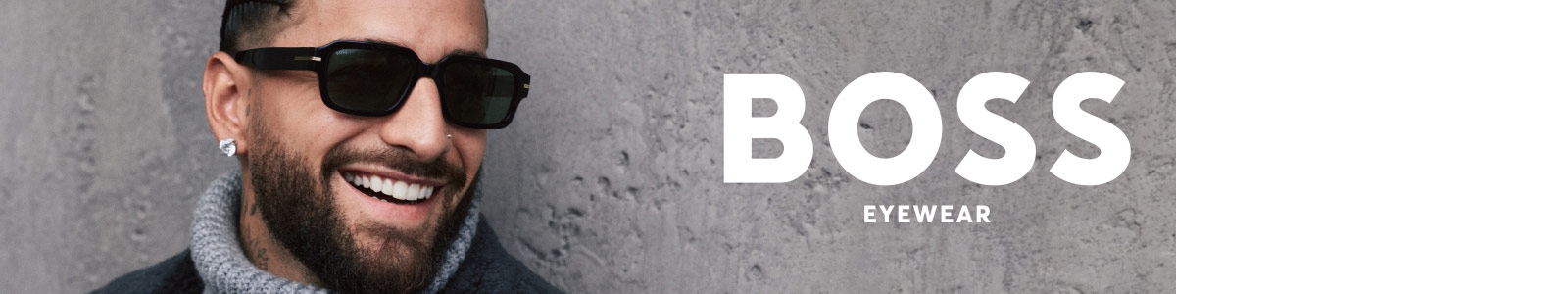 Un homme portant des lunettes de soleil Hugo Boss et de forme ronde